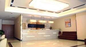 a living room with a couch and a ceiling at GreenTree Inn Shanghai Fengxian District Xiaotang Metro Station in Xidu