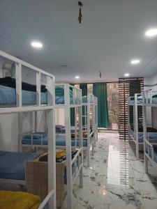 a dorm room with several bunk beds in it at Leesha Tower - Dormitory in Jhānsi