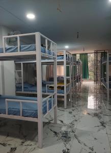 a room with several bunk beds in a room at Leesha Tower - Dormitory in Jhānsi