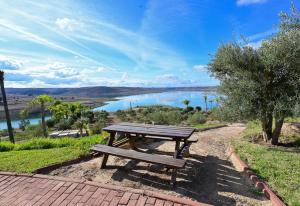 a picnic table with a view of a lake at Lodge du Barrage in Rabat +29 photos