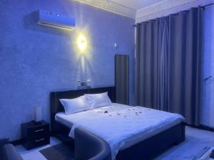 Giường trong phòng chung tại Hotel Divines Graces Residence Inn