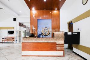 a lobby of a hotel with a reception desk at The Soemarsono Hotel near Ambarrukmo Plaza Mall RedPartner in Yogyakarta
