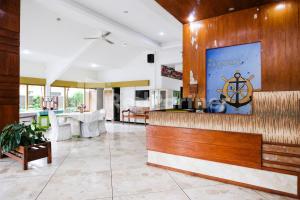 a lobby with a bar in a house at The Soemarsono Hotel near Ambarrukmo Plaza Mall RedPartner in Yogyakarta