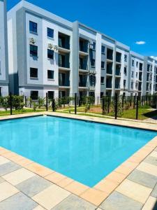 a large swimming pool in front of a building at Stylish Studio Retreat in Gaborone