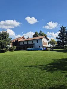 een grote tuin met een huis op de achtergrond bij Cascina Brignolo in Novara