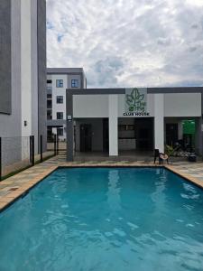 a large swimming pool in front of a building at Stylish Studio Retreat in Gaborone