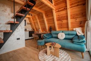 a living room with a blue couch and a table at Homeland Nest in Žabljak