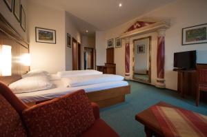 a hotel room with two beds and a television at Hotel Gasthof Sonne in Aschach an der Donau +36 photos