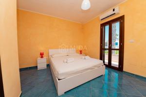 En eller flere senge i et værelse på Orange Sun - Chiusurelle Village