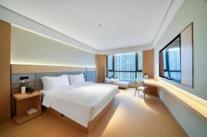 Postel nebo postele na pokoji v ubytování JI Hotel Hangzhou Xiaoshan MixC + 15 fotografií