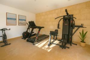 een fitnessruimte met diverse hometrainers in een kamer bij Hotel Boutique Petit París in Port de Pollença