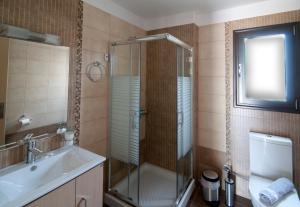 a bathroom with a shower and a sink and a toilet at Riviera Perdika Hotel in Perdika