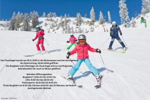 a group of people skiing down a snow covered slope at Apartmenthotel 's Mitterndorf in Traunkirchen