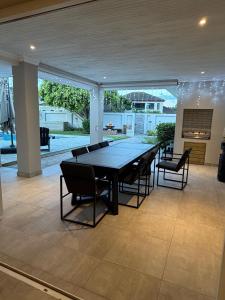 a ping pong table in a room with chairs at 1 Diadem in Plettenberg Bay