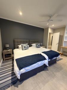 a bedroom with a large bed with two pillows at 1 Diadem in Plettenberg Bay +32 photos