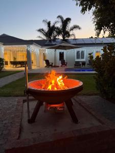 a fire pit in front of a house at 1 Diadem in Plettenberg Bay
