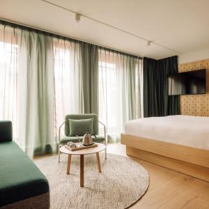 a hotel room with a bed and a chair and a table at Hobo Oslo in Oslo +207 photos
