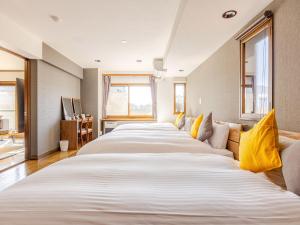 Ένα ή περισσότερα κρεβάτια σε δωμάτιο στο LIT’S INN Sapporo