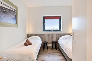 En eller flere senge i et værelse på Vakantie appartement Veerse Muze