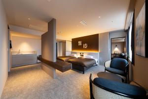 a hotel room with a bed and a chair at Hotel Clio Court Hakata in Fukuoka