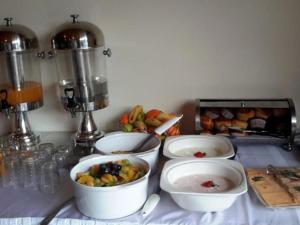 a counter with four bowls of food on a table at Lakefield Hotel in Benoni