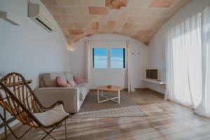 a living room with a couch and a table at Agroturismo Son Vives Menorca - Adults Only in Ferreries