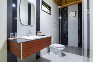 a bathroom with a sink and a toilet and a mirror at Medee Resort in Ko Kood