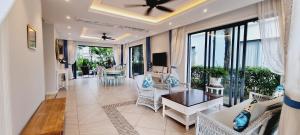 a living room with a table and chairs at LumiShora Villa - Bai Truong, Phu Quoc in Phú Quốc