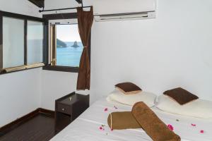 a bedroom with a bed with a view of the ocean at Sunny views studios in Agios Gordios