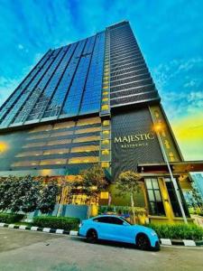 a blue car parked in front of a building at Majestic Residence Klcc by Luxury in Kuala Lumpur