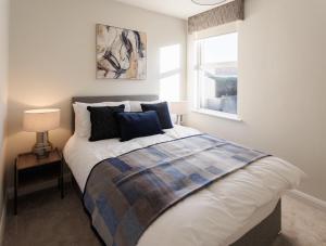 a bedroom with a bed with pillows and a window at The Views Retreat in Newcastle