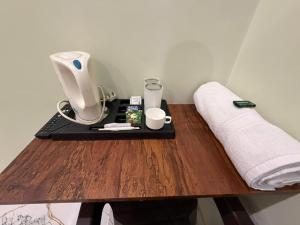 a table with a coffee maker and cups on it at Jogi Lodge in Varanasi