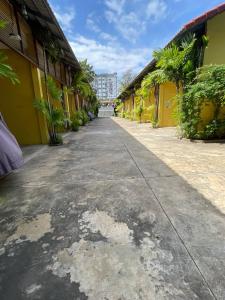 an empty street in front of a yellow building at Maam Guesthouse in Phnom Penh