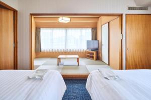 Postel nebo postele na pokoji v ubytování Court Hotel Fukuoka Tenjin