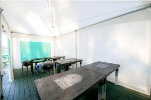 a room with tables and chairs in a tent at Gangneung Maison de Rose in Gangneung