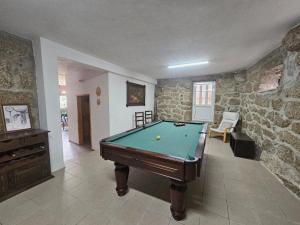 a room with a pool table in a house at Casa de Emaús - Gerês in Terras de Bouro