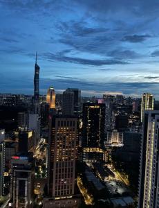 a view of a city skyline at night at Majestic Residence Klcc by Luxury in Kuala Lumpur