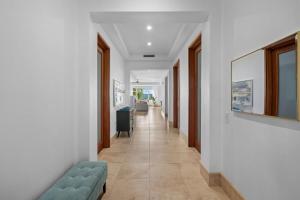 einen Flur mit weißen Wänden und einer blauen Couch in der Unterkunft Villa Jasmine Ritz Reserve Plantation residence in Higuillar