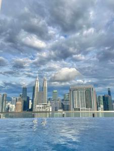 a view of a city skyline from the infinity pool at Majestic Residence Klcc by Luxury in Kuala Lumpur