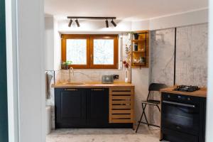 a kitchen with a counter and a sink and a window at Villa Octogon Câmpina in Campina