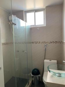 a bathroom with a glass shower and a toilet at Acogedores pisos en el valle de Mala in Mala
