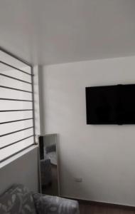 a living room with a couch and a flat screen tv at Acogedores pisos en el valle de Mala in Mala +5 photos