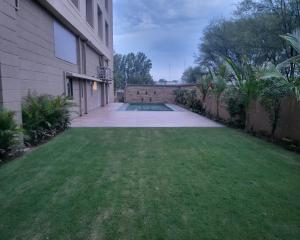 a yard with a pool in the middle of a house at Sangath Banquet & Resort in Nadiad +13 photos