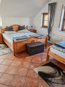 a bedroom with a large wooden bed and a window at Landhaus am Brubbel in Wallenborn