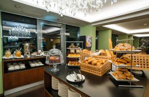 a bakery with bread and pastries on a counter at Ibercity Wien Schönbrunn in Vienna