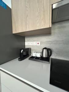 a kitchen counter with a coffee pot on a stove at AFRODITI Living in Nicosia +4 photos