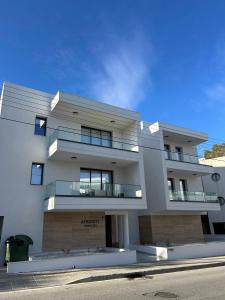 a large white building with balconies on a street at AFRODITI Living in Nicosia