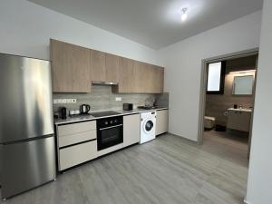 a kitchen with a refrigerator and a washer and dryer at AFRODITI Living in Nicosia