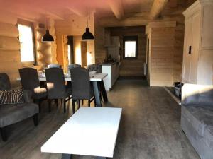 a kitchen and dining room with a table and chairs at Chalet Marmotte am Nassfeld in Hermagor +12 photos