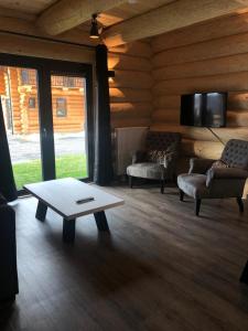 a living room with two couches and a coffee table at Chalet Marmotte am Nassfeld in Hermagor
